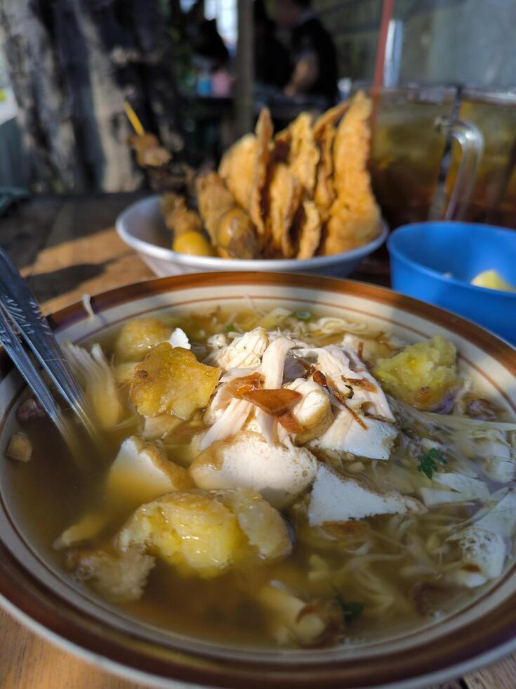 Soto is an Indonesian food, a soup mainly composed of broth, chicken and vegetables, often served with tempeh fried chips. photo