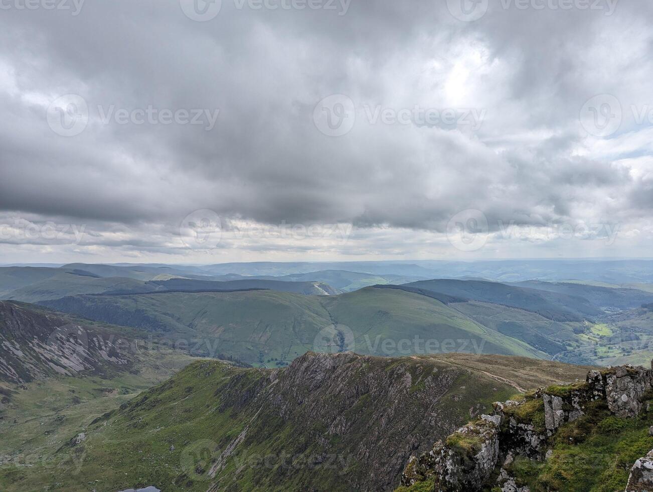Breathtaking Mountain Landscape Under Cloudy Sky photo