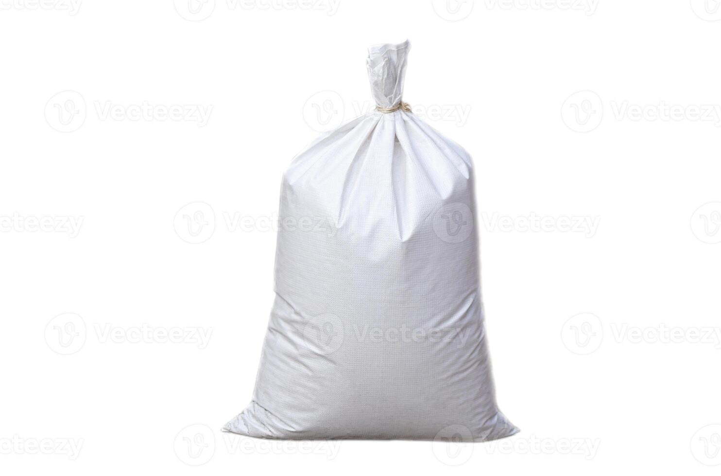 White polypropylene sack that contain full of agricultural grains, tied on the top with bamboo rope, isolated on white background. Concept, reusable bag for contain crops, fertilizer, others. photo