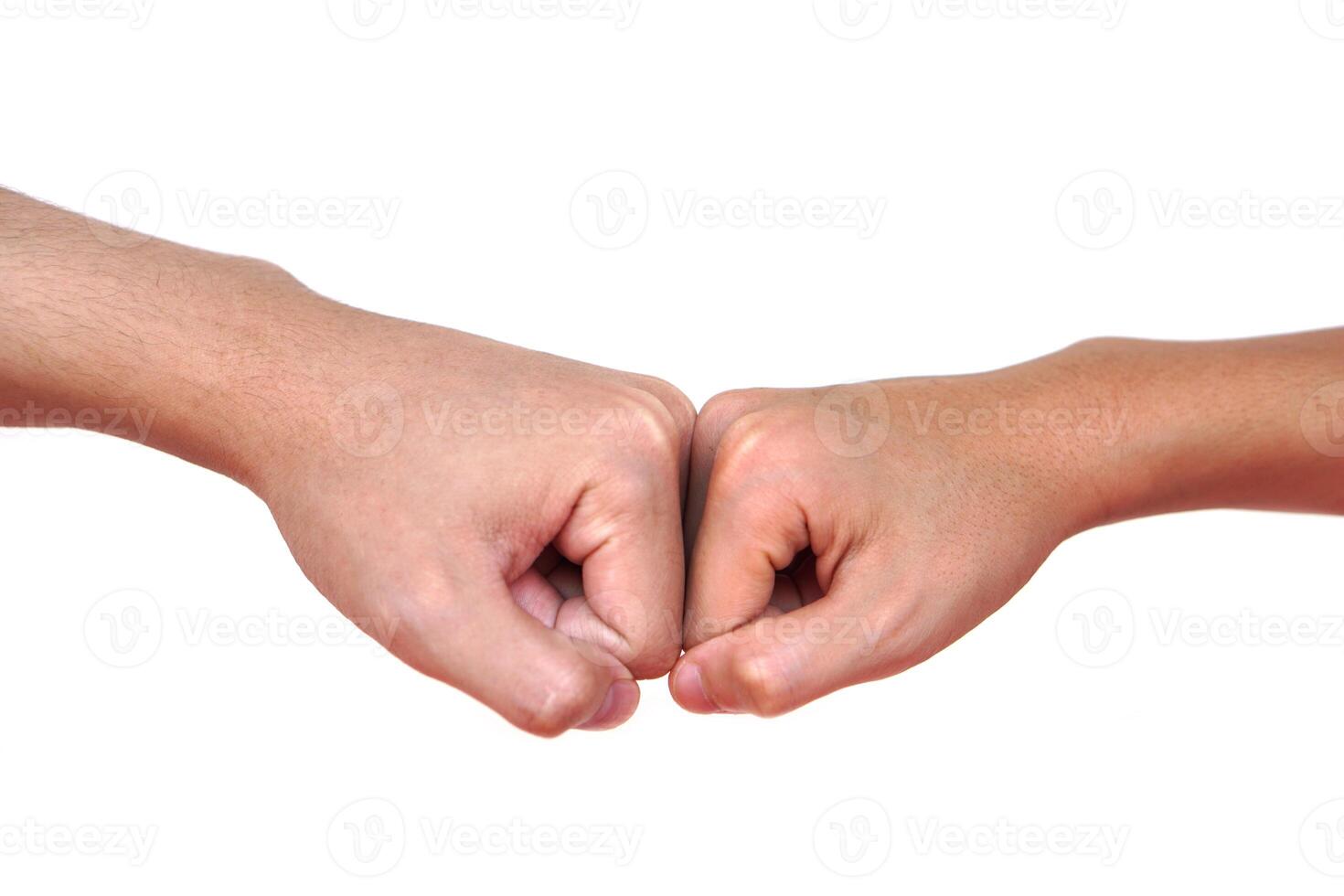 Close up two hands bump their fists together for greeting. Concept, Body language. Hands gesture symbol for greeting, giving respect or approval as companionship between two people. photo