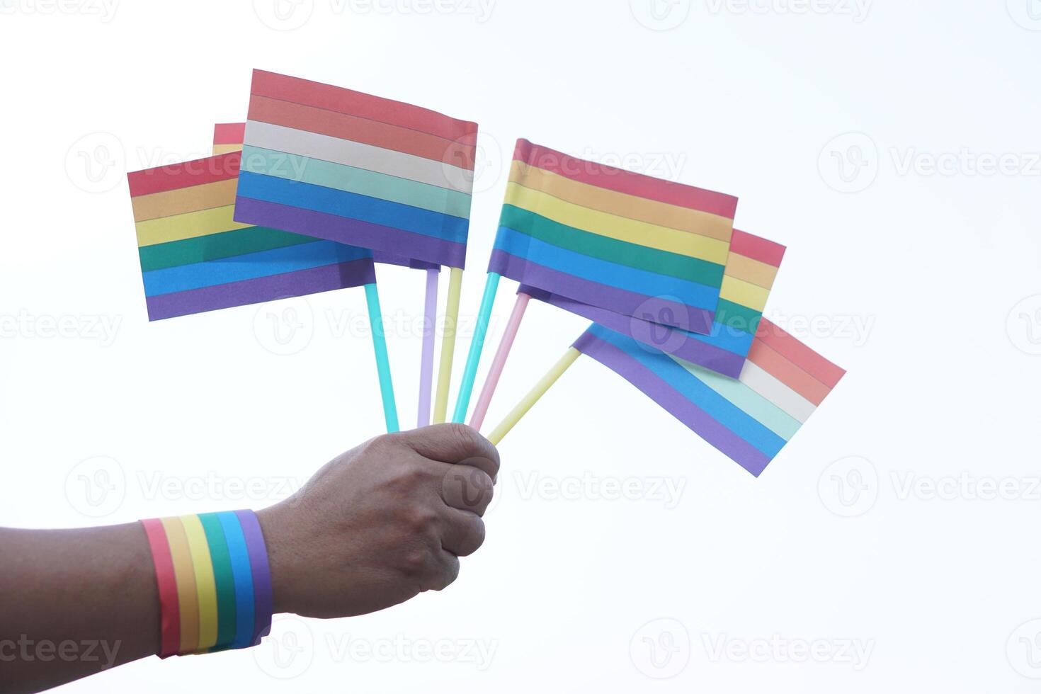 Close up hand holds rainbow colors flags. Concept, Lgbtq celebration in pride month, June. Symbol of LGBT community around the world.Support human right of gender diversity. photo