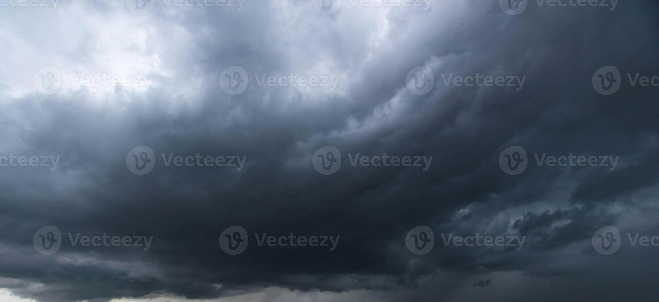 Bad or moody weather sky and environment. The dark sky with heavy clouds converging and a violent storm before the rain. carbon dioxide emissions, greenhouse effect, global warming, climate change photo