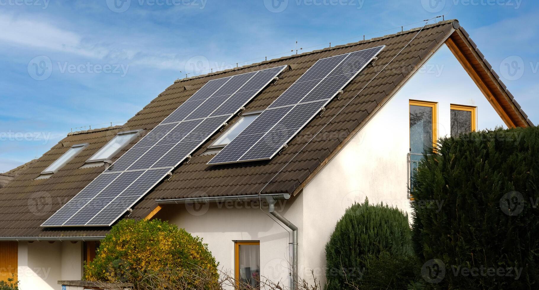 Home solar panel. Alternative energy is used for heating and water heating. Eco-friendly alternative energy for house. Residential family house suburban. Brown tile roof of home with solar panels. photo