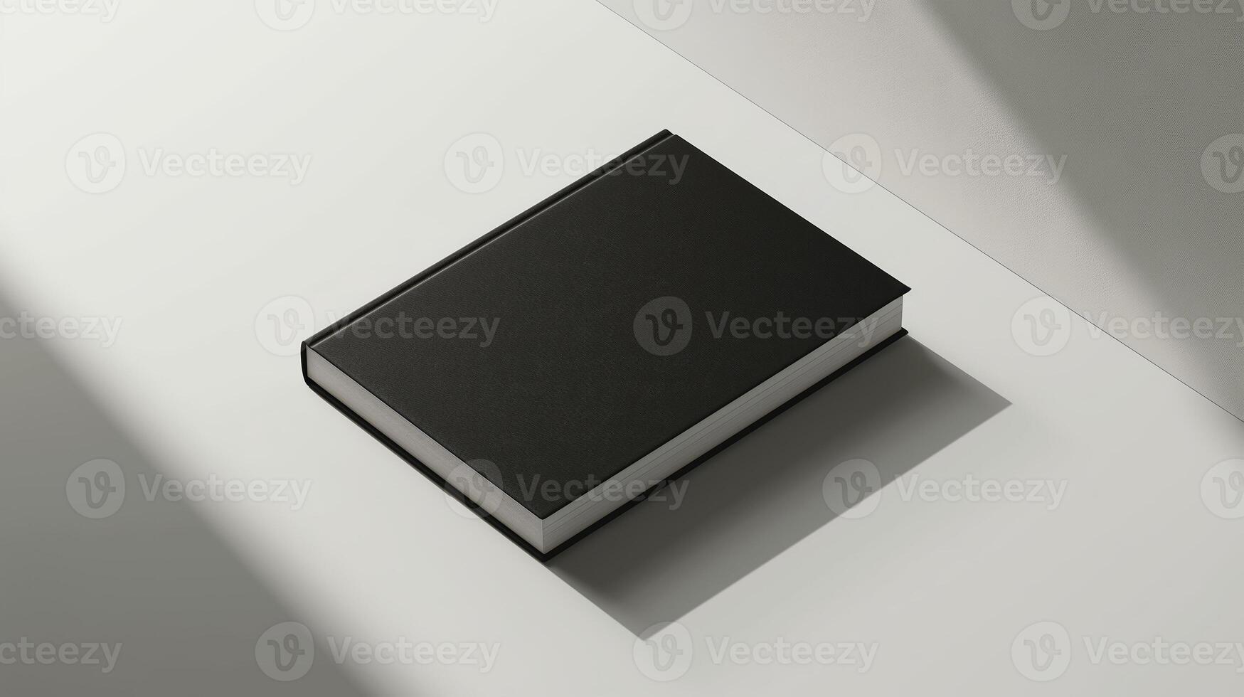 Black book on a white table with a shadow. Minimalist book mockup with a plain cover and copy space for text, suitable for graphic design presentations and publishing concepts. photo
