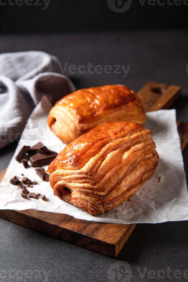 Chocolate Shortbread puff pastry with fork served in dish isolated on dark background side view of baked cafe food photo