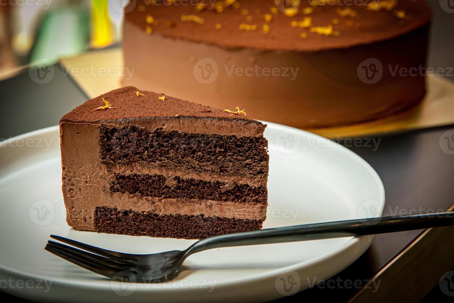 Triple Extra Rich Chocolate Cake with fork served in plate isolated on background side view of baked cafe food photo