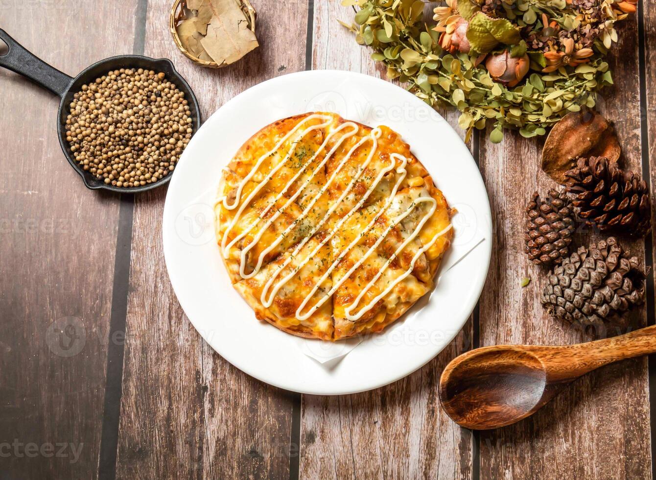 Mayonnaise Pizza with spoon and fork served in plate isolated on wooden table top view of taiwan fasfood photo