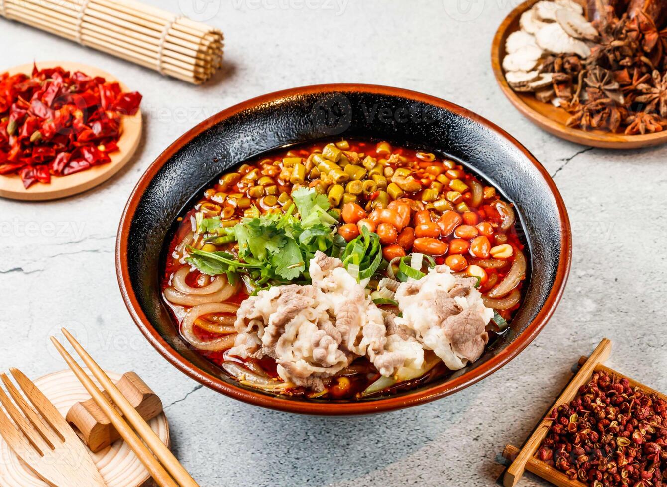 Beef hot and sour rice noodles, coriander, beans with red chilli, chopsticks and fork served in pot isolated on background side view of taiwanese food photo