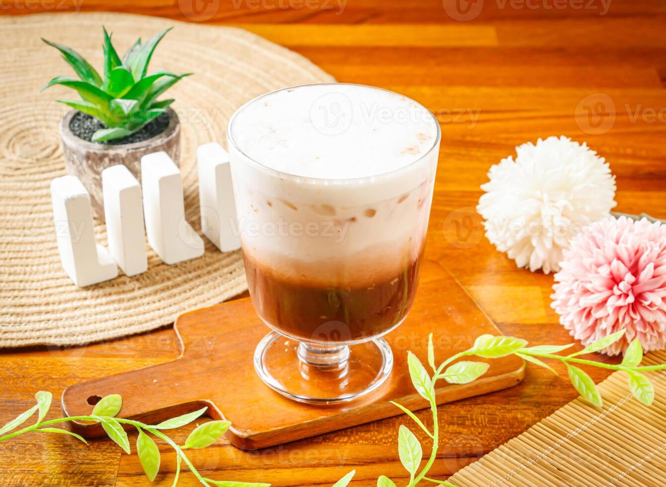 Cocoa Ole milk iced tea served in cup isolated on wooden table side view of Taiwan drink photo