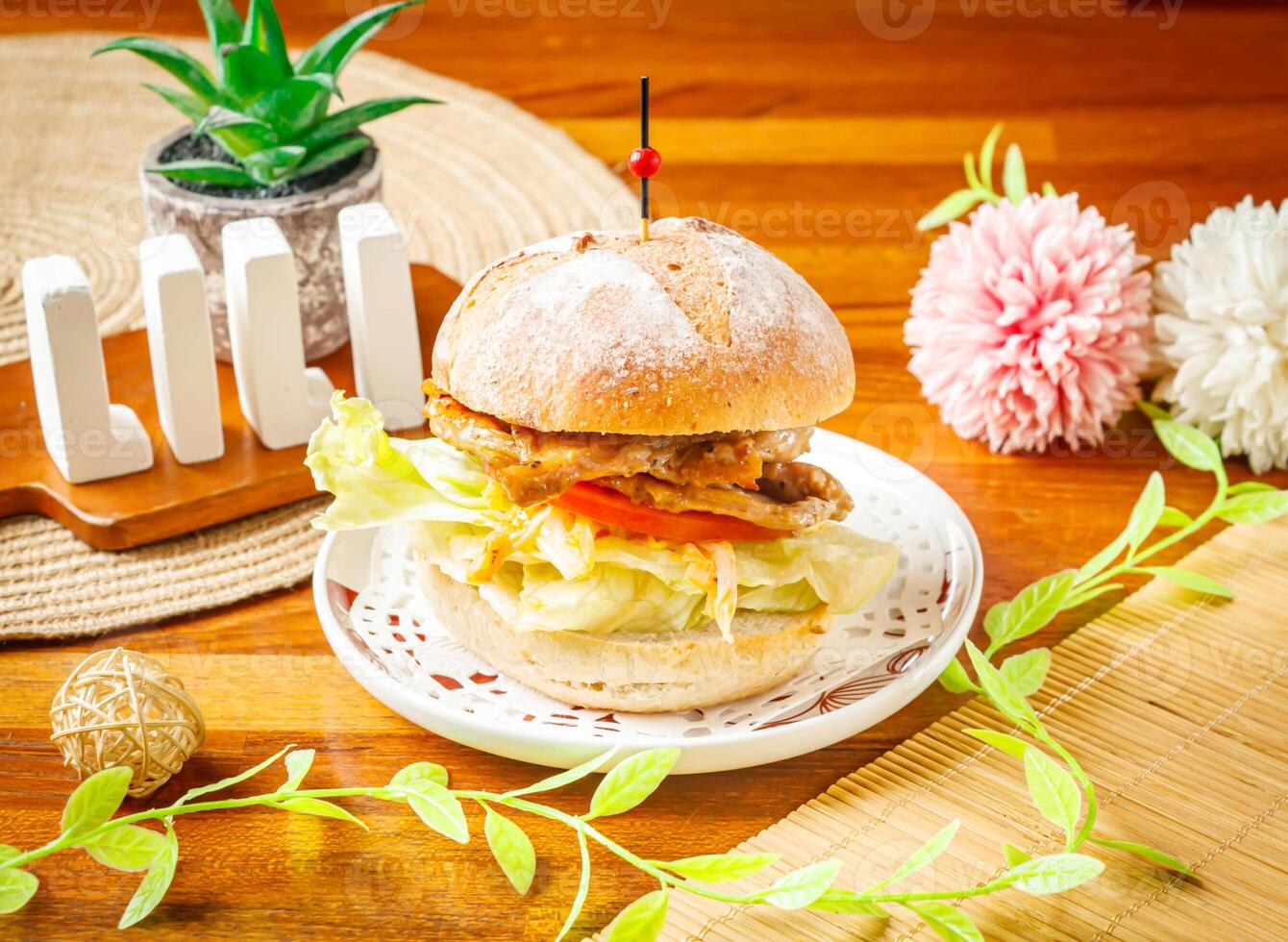 Countryside Roasted Pork Burger with cabbage and tomato served in dish isolated on wooden table side view of taiwan food photo