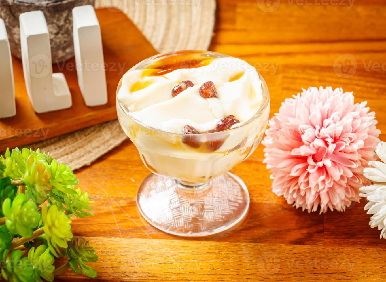 Tofu Pudding served in cup isolated on wooden table side view of Taiwan dessert drink photo