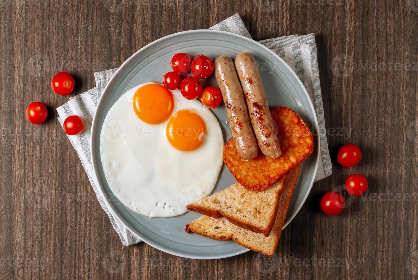 Breakfast dish Bratwurst Eggs Toast And Hasbrown with Pancake, bacon pastrami fried eggs and cheese in dish on dark wooden table top view food photo