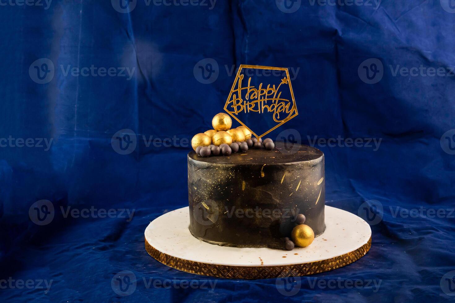 Happy Birthday chocolate Cake with choco balls, fork and knife served in stand isolated on napkin side view of cafe baked food photo