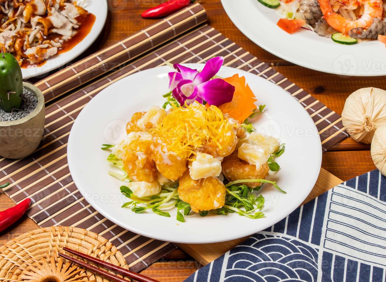 Pineapple Shrimp Balls with chopsticks served in dish isolated on table side view taiwanese food photo