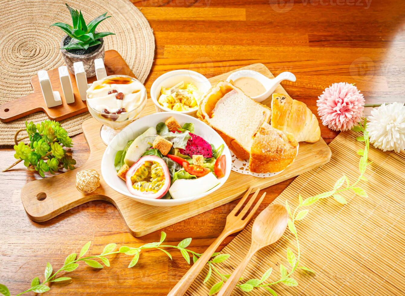 Vegetable and Fruit Salad with dragon fruit, passion fruit, cabbage, lettuce and tomato, Lemon Cake and Tofu Pudding served in dish isolated on wooden table side view of taiwan food photo