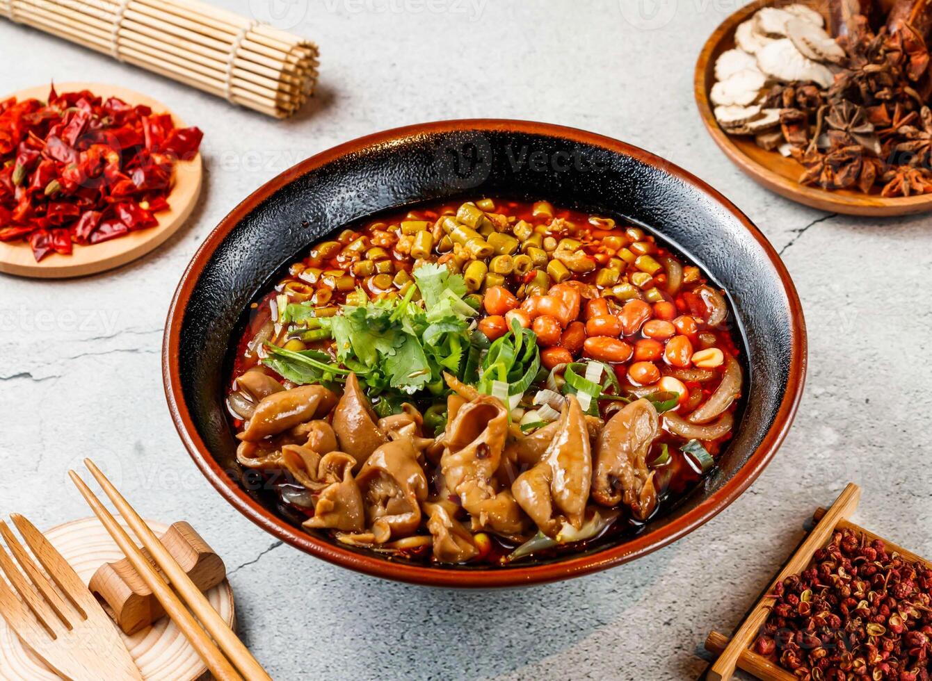 Fat intestine hot and sour rice noodles with coriander, beans, red chilli, chopsticks and fork served in pot isolated on background side view of taiwanese food photo