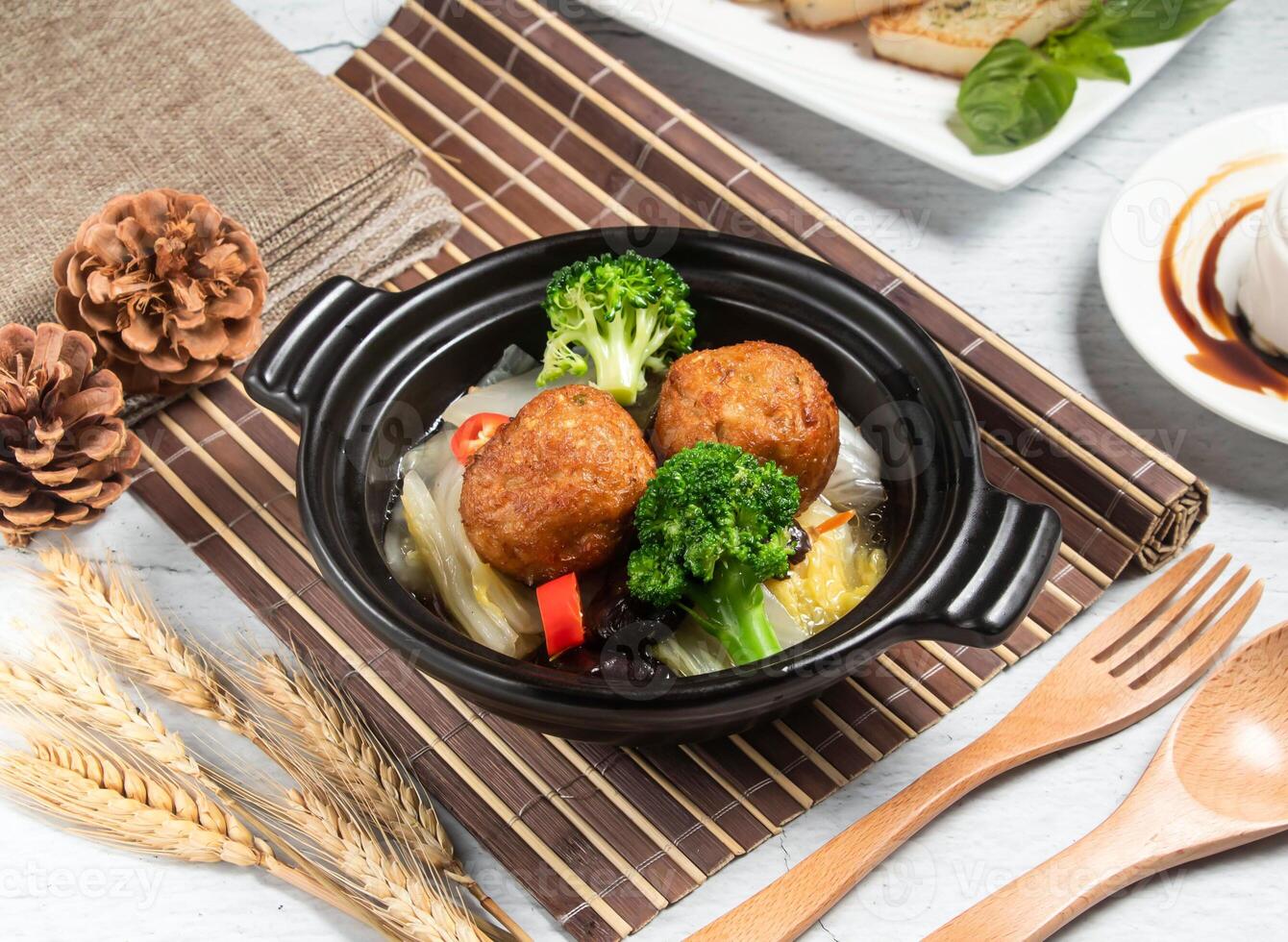 Lion's Head Dinner with wheat, spoon and fork served in broth isolated on napkin side view of taiwanese food photo