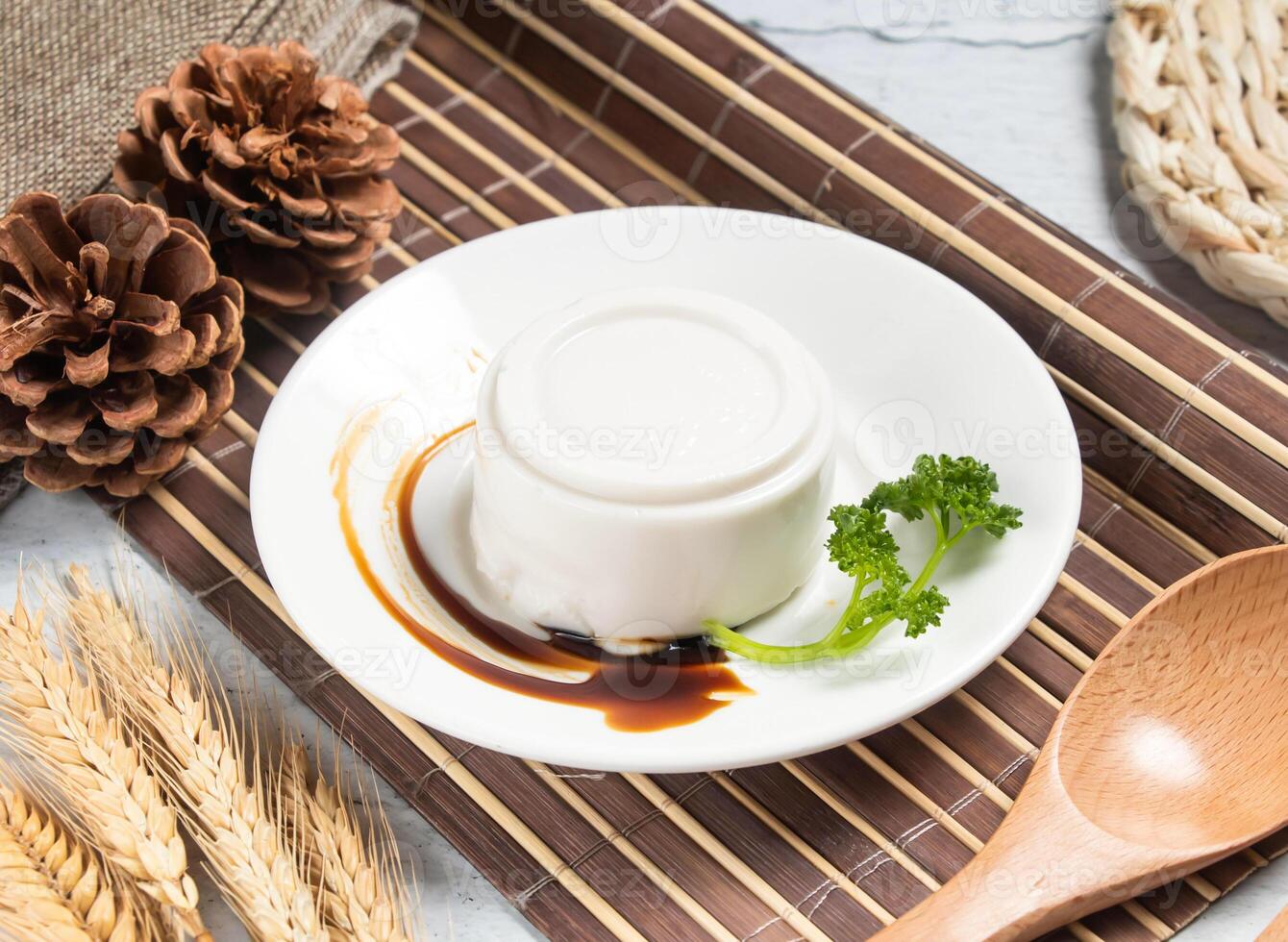 coconut pudding or Peanut tofu curd with wheat, spoon and fork served in dish isolated on napkin side view of taiwanese food photo
