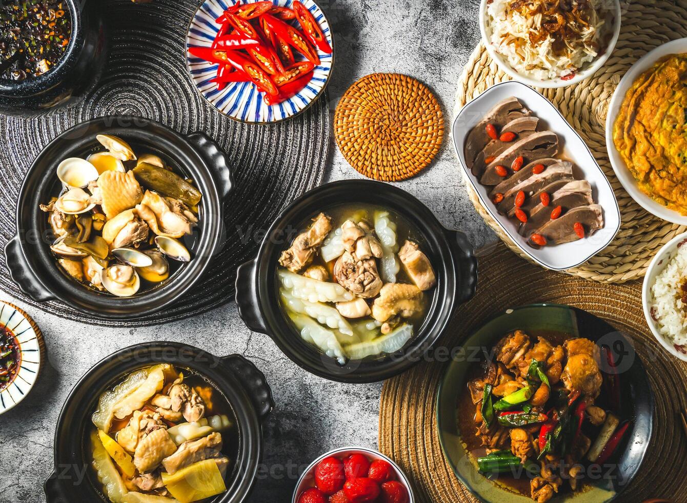 Pineapple Bitter Melon Chicken, Peeled Chili Clam Chicken, Braised chicken with soy sauce, rice, Pickled plum tomatoes, Fried scallions eggs omelet served isolated top view of assorted taiwan food photo