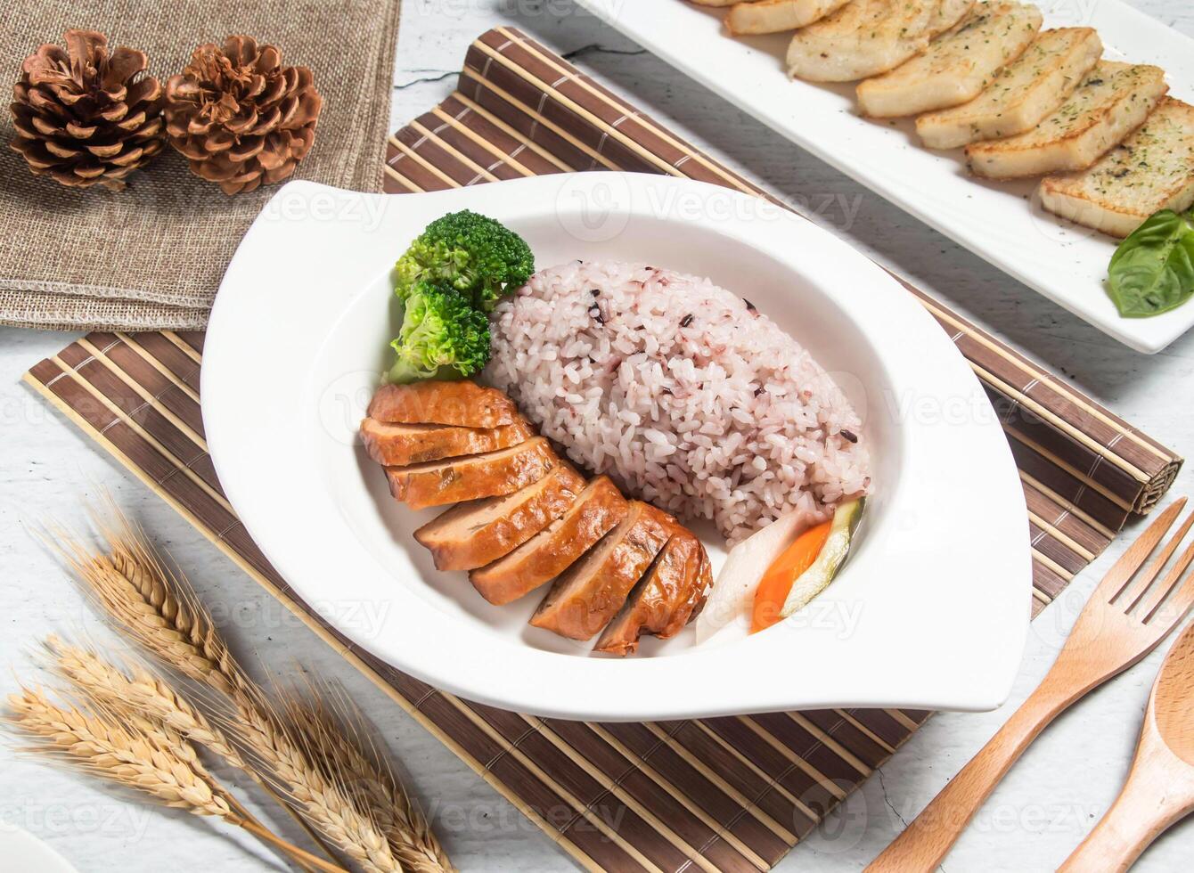 Hong Kong Style BBQ Pork Chicken Leg Rice with wheat, spoon and fork served in dish isolated on napkin side view of taiwanese food photo