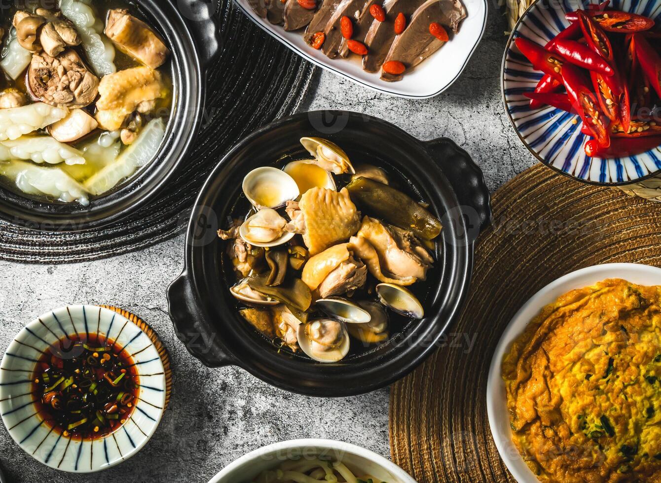 Peeled Chili Clam Chicken served in broth isolated on grey background top view of assorted taiwan food photo