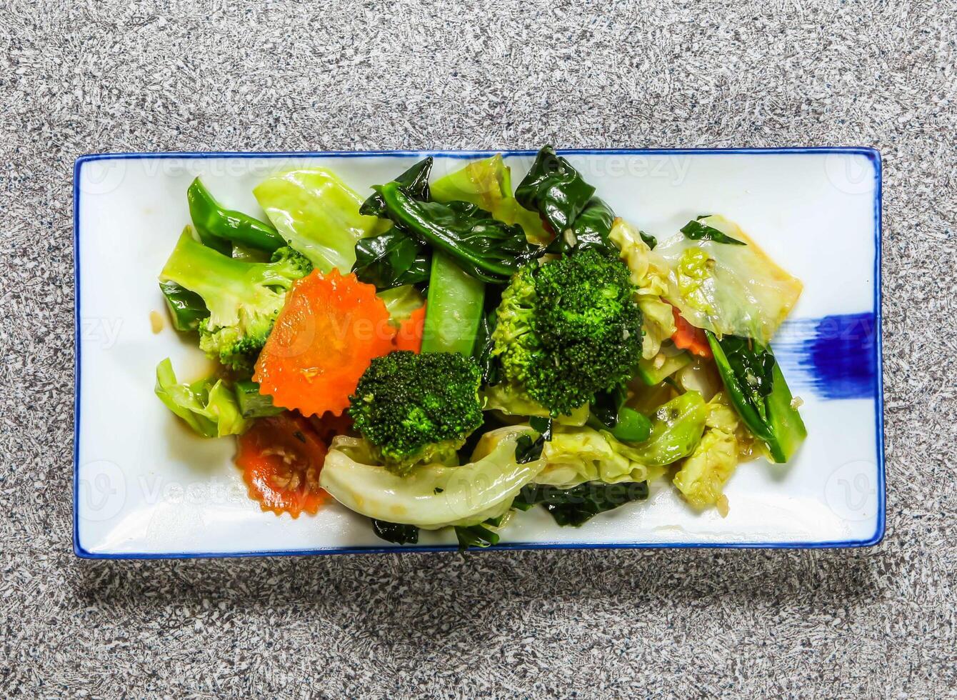 fried mixed vegetables with broccoli, cabbage, kale and carrot served in tray dish isolated on grey background top view hong kong healthy green food photo