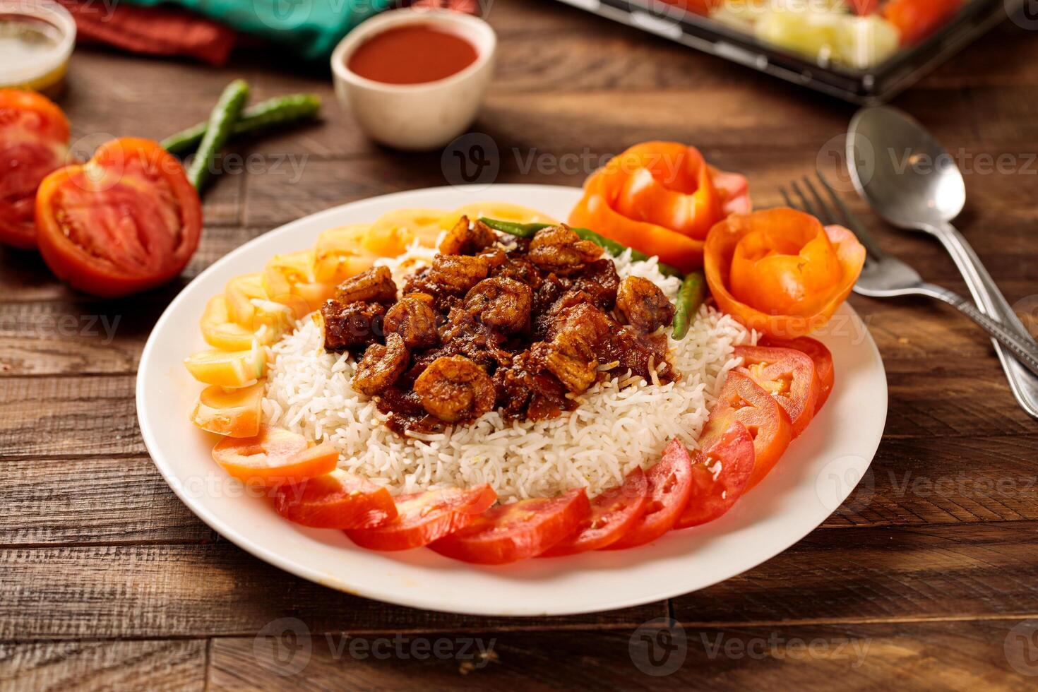 Hamsa prawns with white rice, tomato and sauce served in a dish isolated on wooden table background side view of fastfood photo
