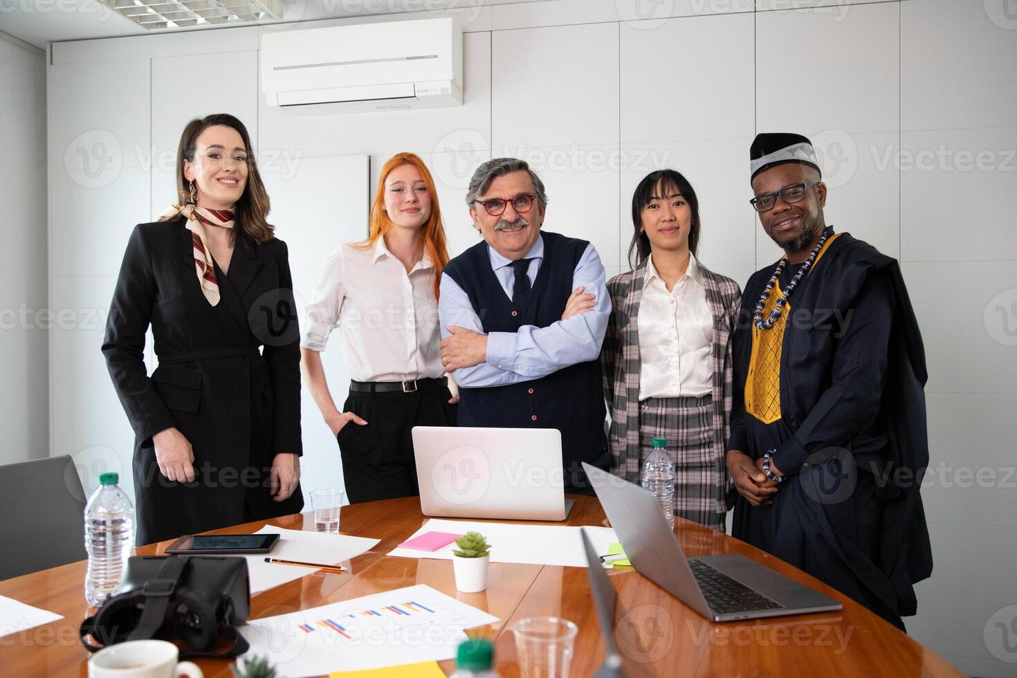 Group of business people pose together during a meeting, multi ethnic group photo