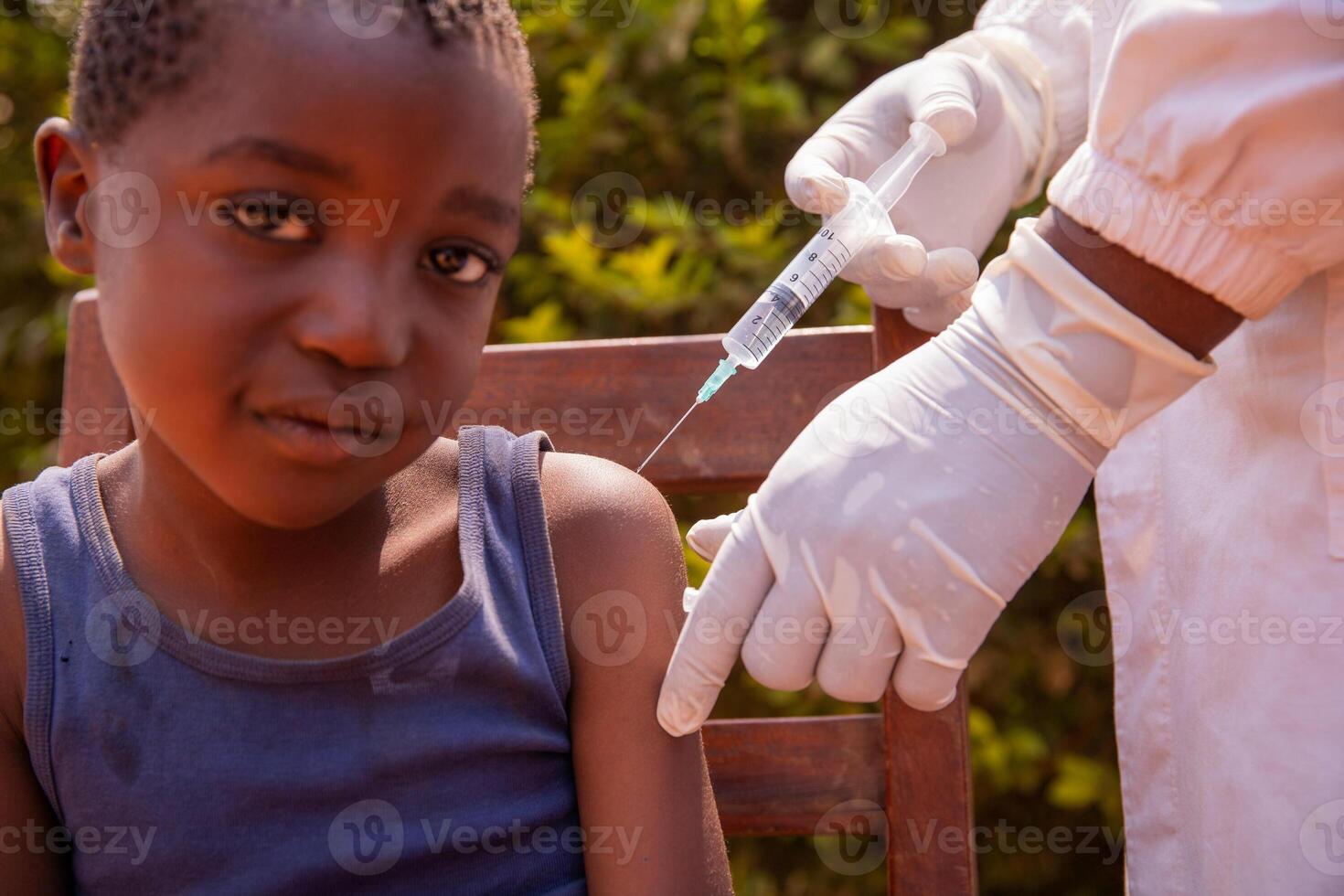 An African child is vaccinated by a doctor, disease prevention in Africa photo