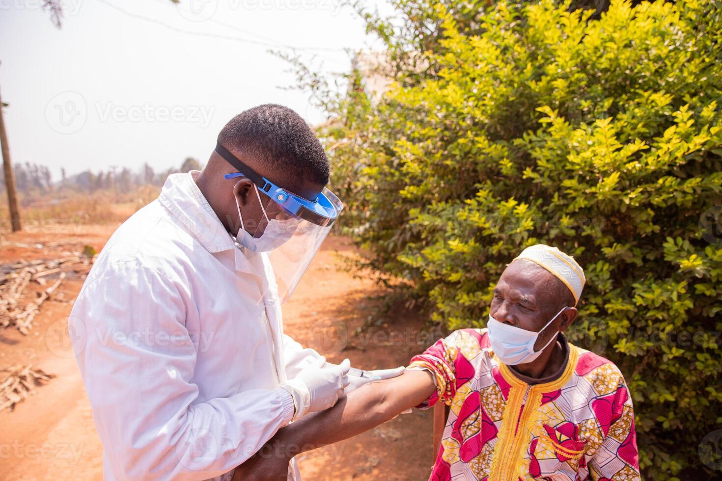 Senior african man getting vaccinated outdoor during Covid-19 pandemic era photo