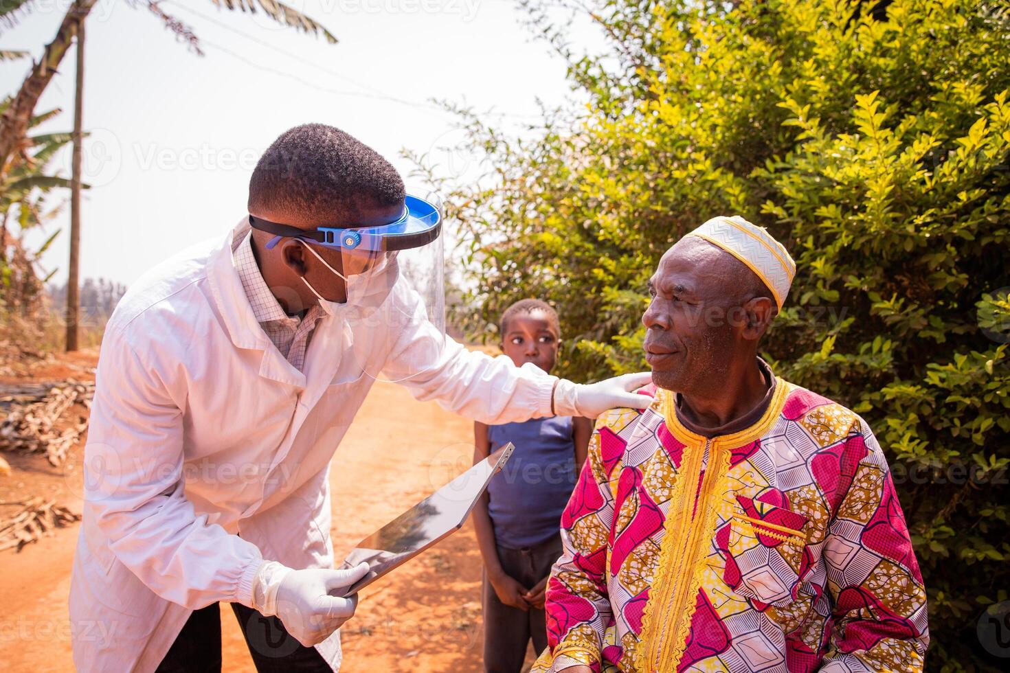 African doctor visits an elderly patient and they converse during the medical examination. Health care in africa concept photo