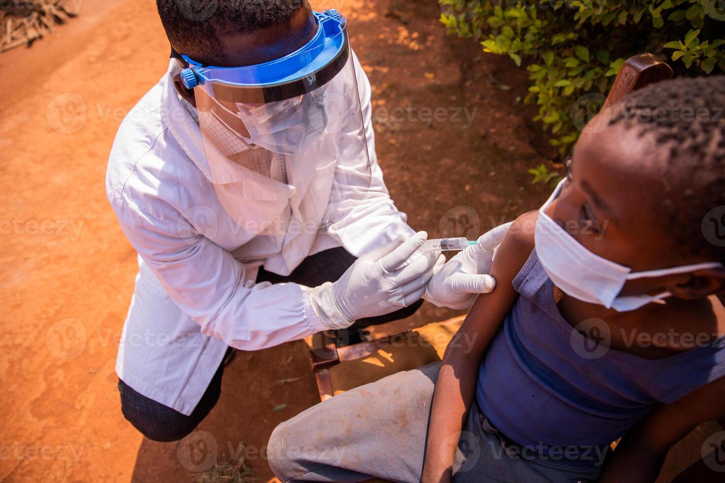 A doctor vaccinates a child in Africa during a medical visit photo