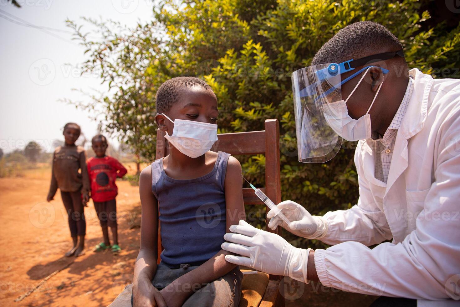 Open air vaccination session in an african village during corona virus pandemic photo