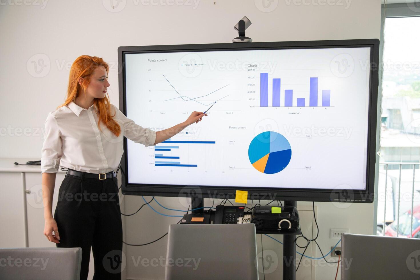 A businesswoman explains slides during a presentation photo
