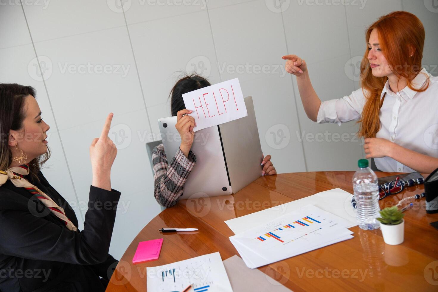 A businesswoman asks for help because she is treated badly by her colleagues at work photo