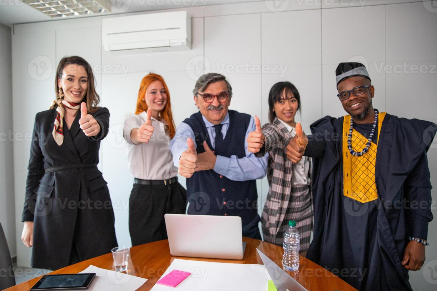 Group of business people show thumb up, positivity during meeting photo