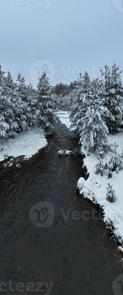 Amazing Cinematic Aerial View On Freezing River. Aerial View Flight Above Frozen Creek Scenic View Of Nature photo