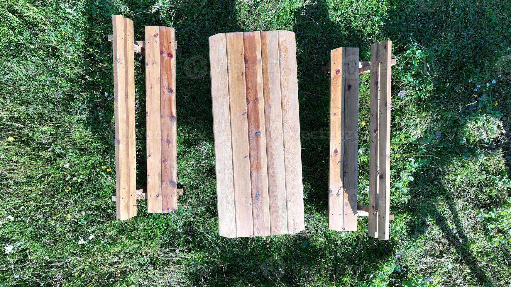 Rustic wooden picnic table in the backyard top view photo