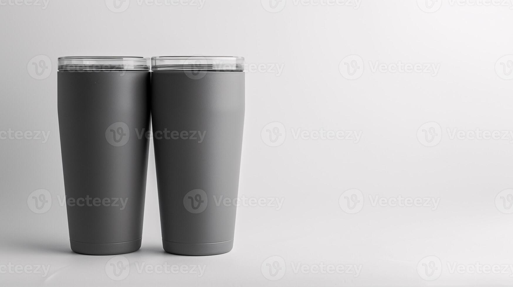 A close-up view of two matte gray 20-ounce short tumblers with a clean white background, Generated AI photo