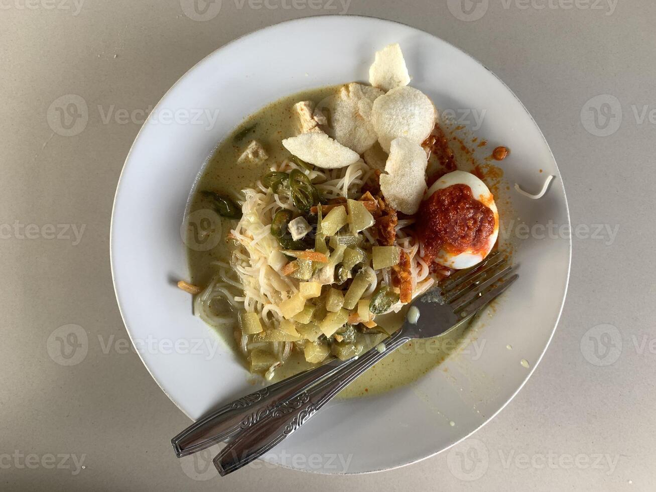 a plate of lontong noodles on the table. photo