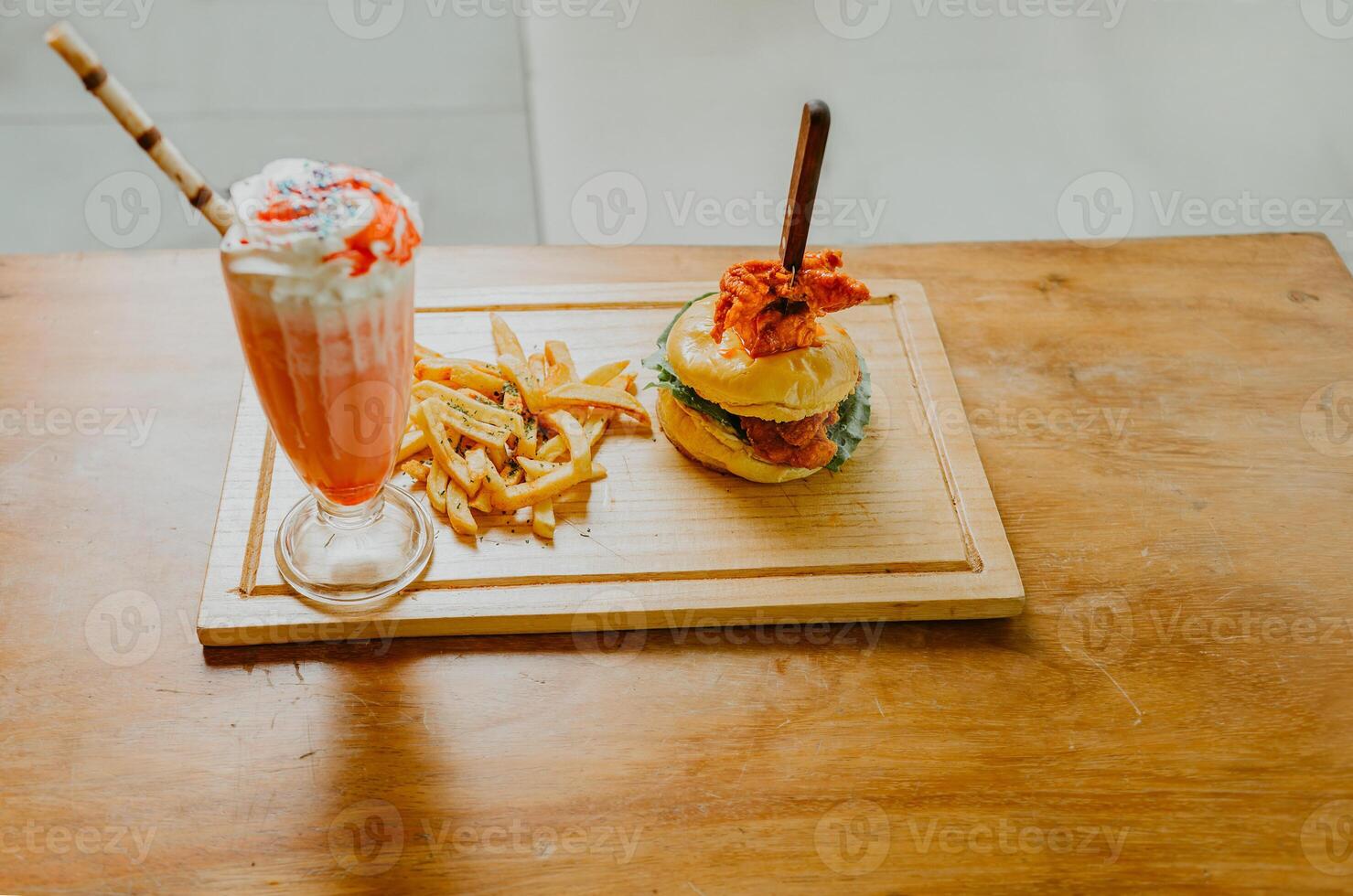 Hamburger with french fries and strawberry milkshake on wooden table isolated photo