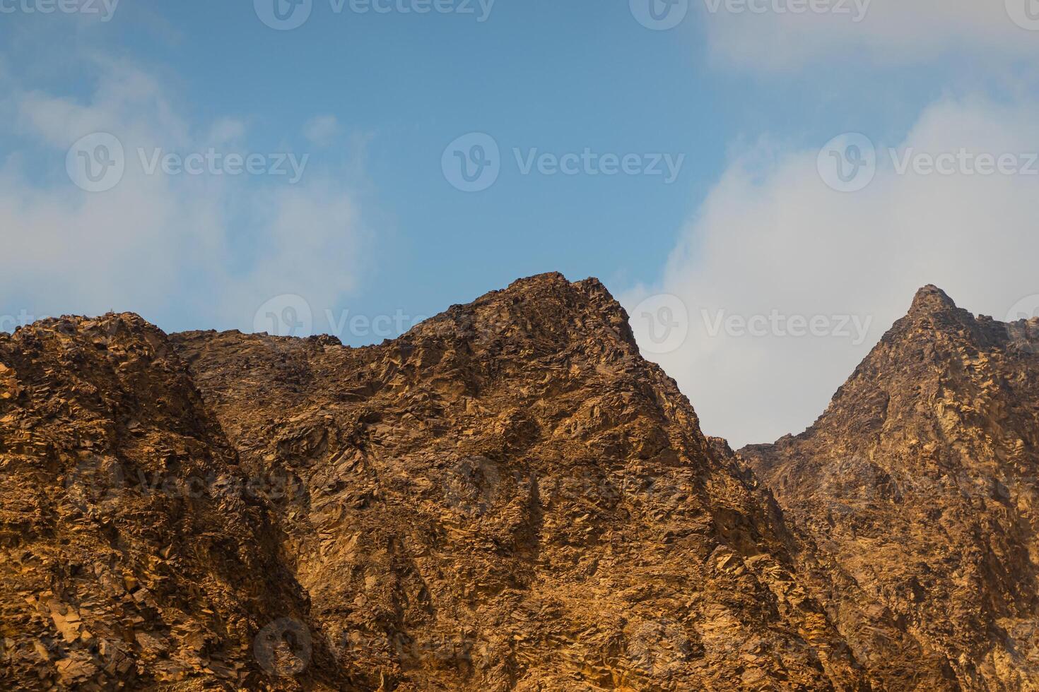 Fujairah mountains, extension of Omani Al Hajar mountain range. Cloudy winter day on empty street. photo