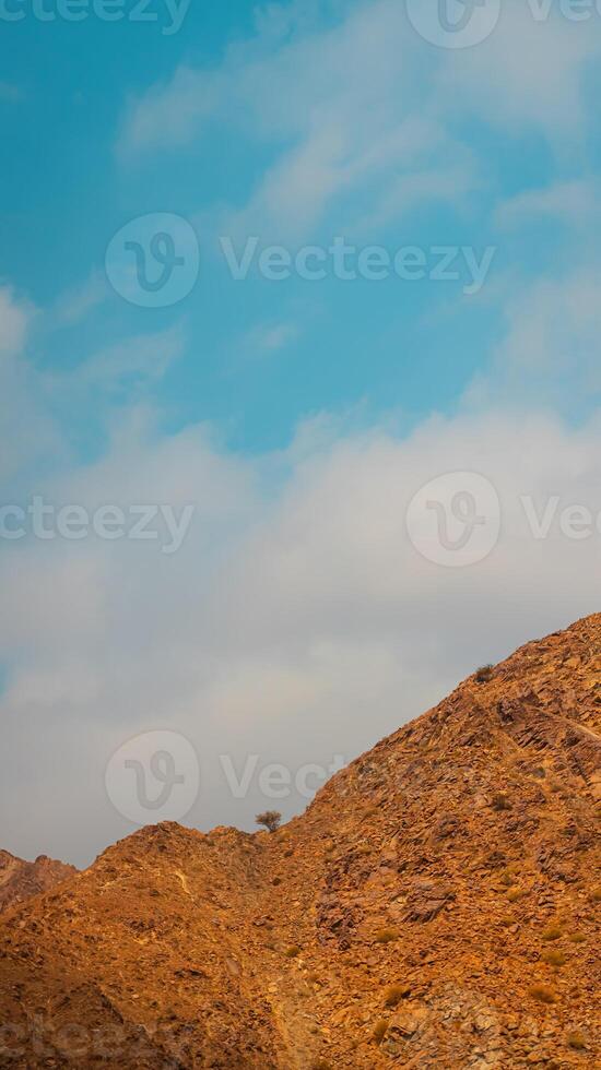 Fujairah mountains, extension of Omani Al Hajar mountain range. Cloudy winter day on empty street. photo