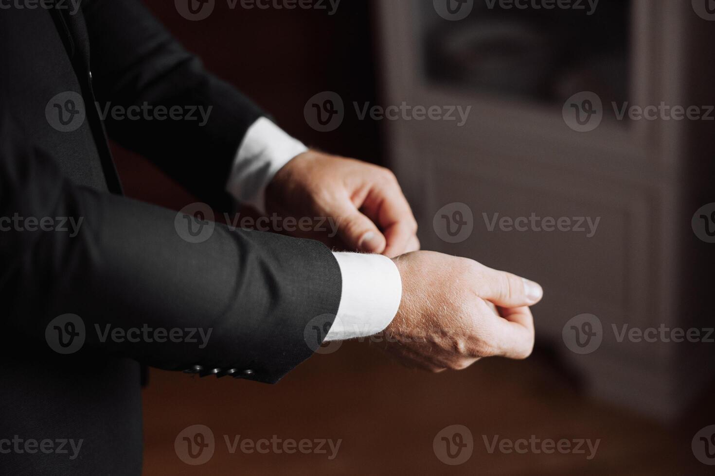 A man in a suit is getting ready to dress up photo