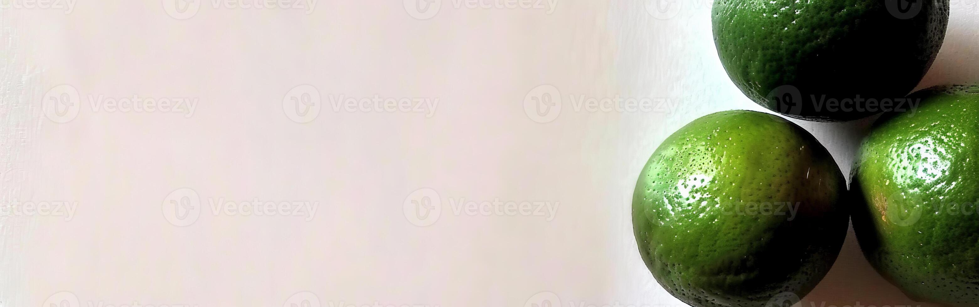 Three Fresh Green Lemons on a White Surface photo