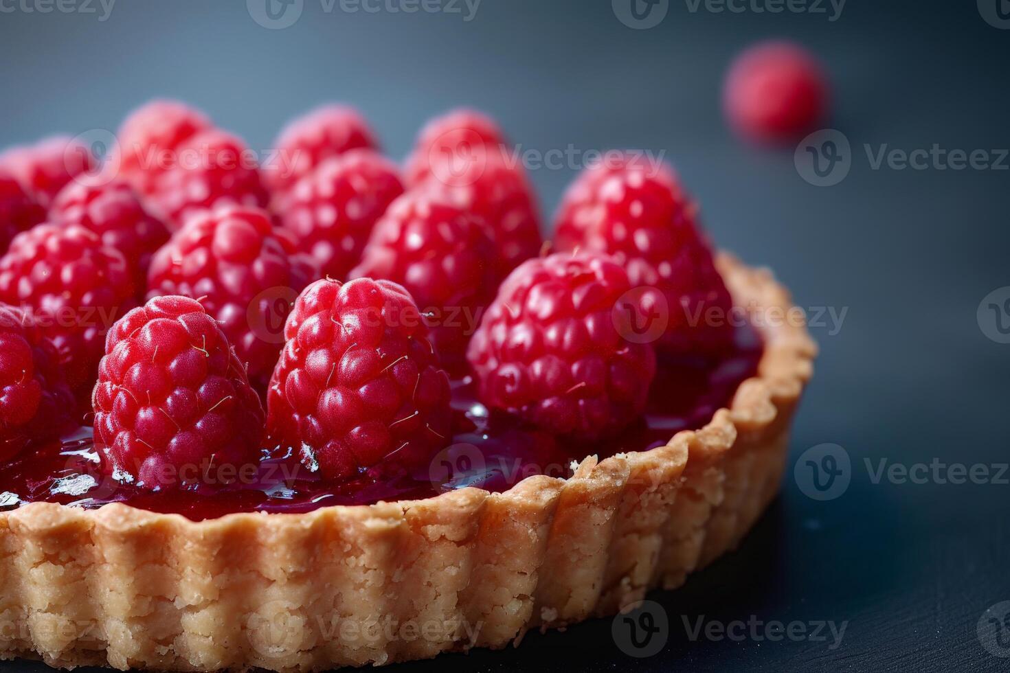 Ripe Raspberry Tart With Flaky Crust on Dark Background photo