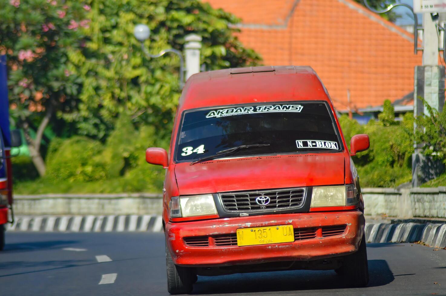 Public transportation or angkot are red on Indonesian highways, Indonesia, 20 May 2023. photo