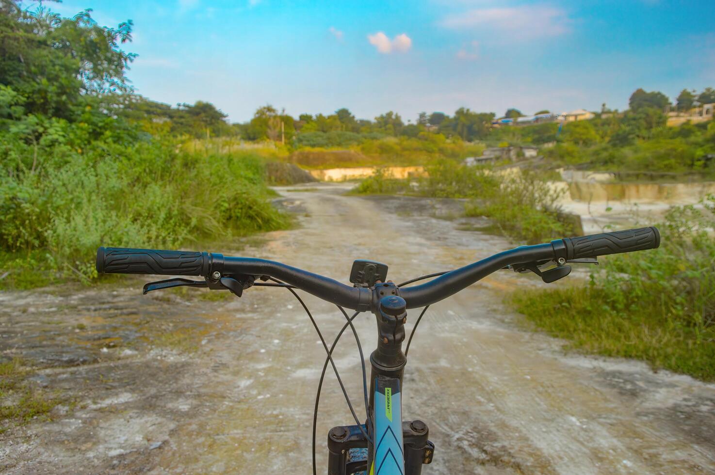 the handlebar of a pedal bike being ridden in a limestone quarry, Indonesia, 20 May 2023. photo