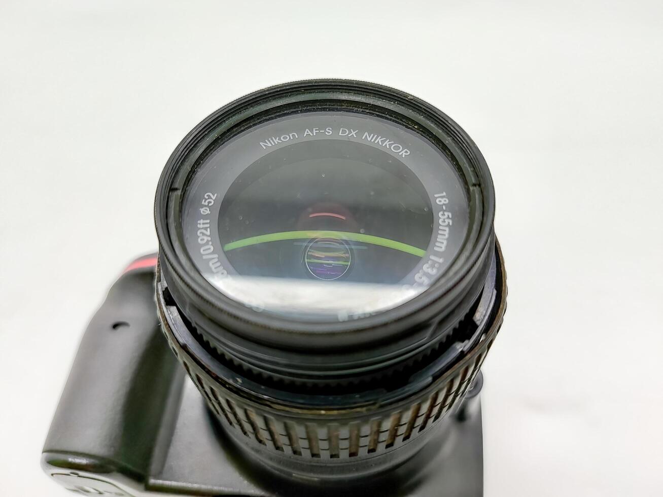 an old nikon d3200 dslr camera with kit lens isolated on white background, Indonesia, 28 May 2024. photo