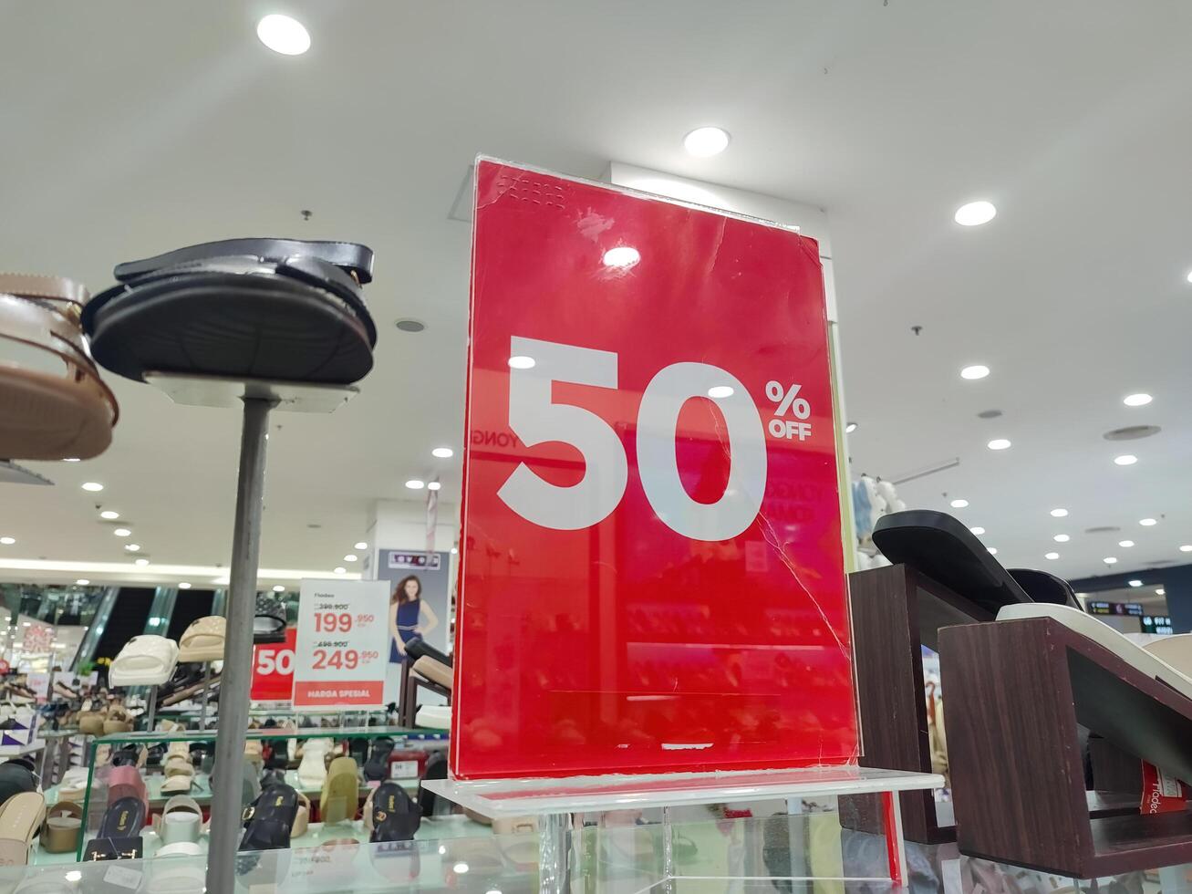 a board that says fifty percent discount in red in a clothing store or department store, Indonesia, 28 May 2024. photo